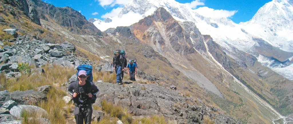 A climber using two ice axes to ascend the steep, technical ice wall (60-70°) on Nevado Yanapaccha (5460m).